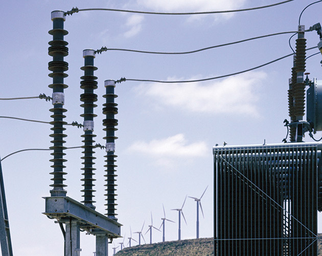 Trans Rupter II Transformer Protector with blue skies behind a line up of wind turbines Trans-Rupter II Transformer Protector, transformer protector, overhead switchgear, distributions